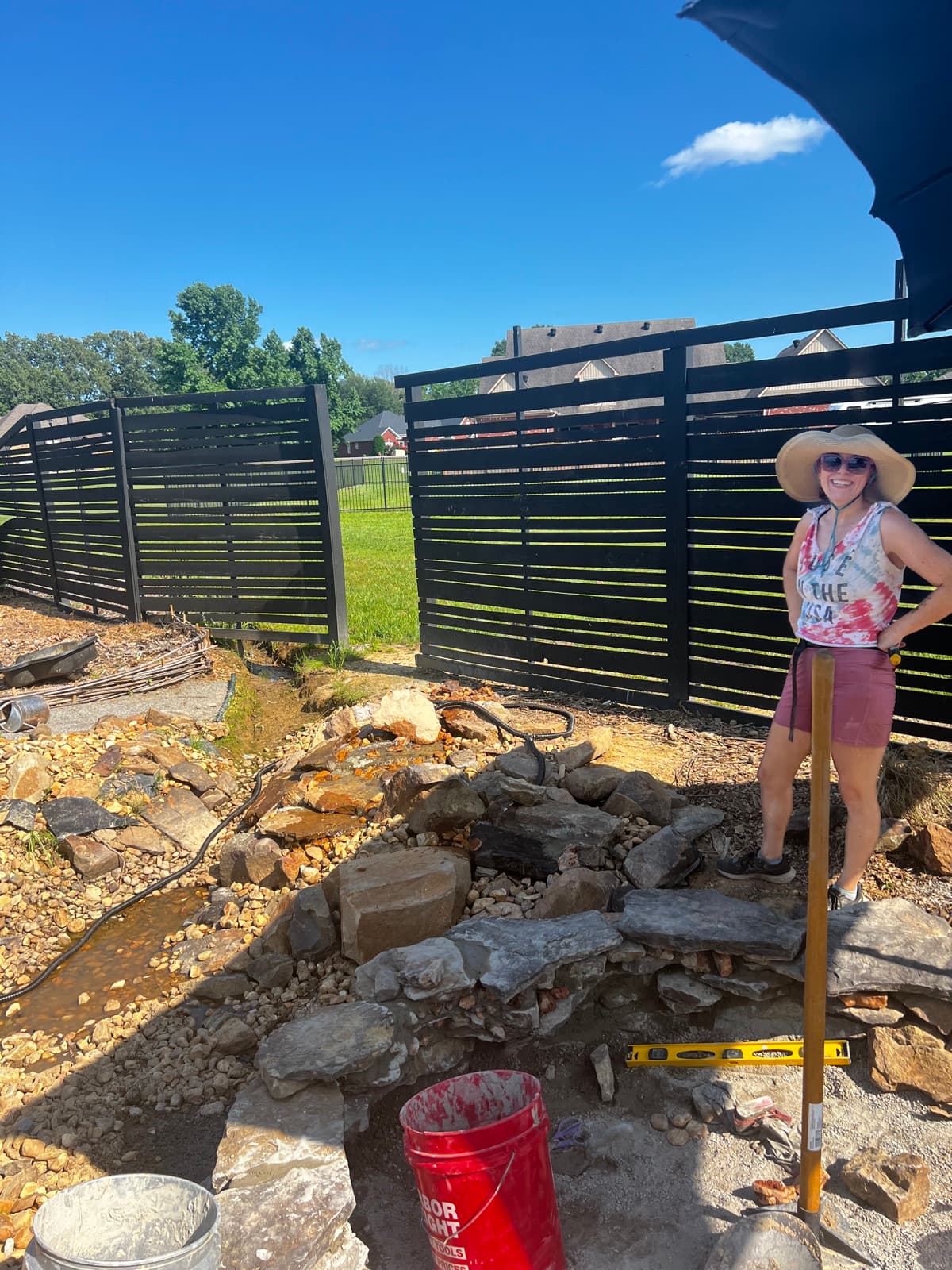 Lauren building the water feature on the farm